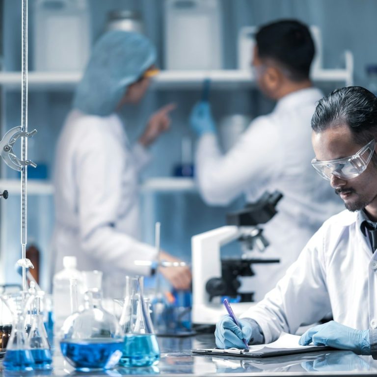 cosmetic laboratory scientist with a beaker of emulsion cosmetic laboratory scientist with a beaker of emulsion