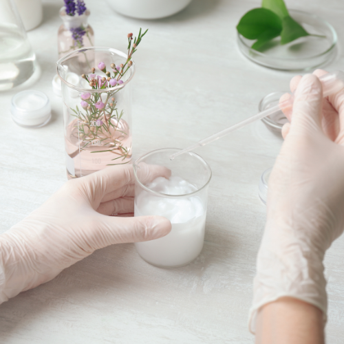 cosmetic laboratory scientist with a beaker of emulsion cosmetic laboratory scientist with a beaker of emulsion